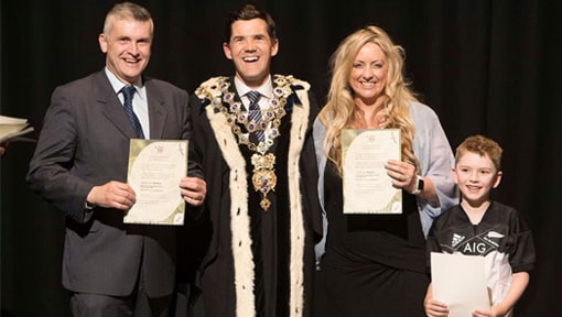 Matthew Needham receiving a certificate